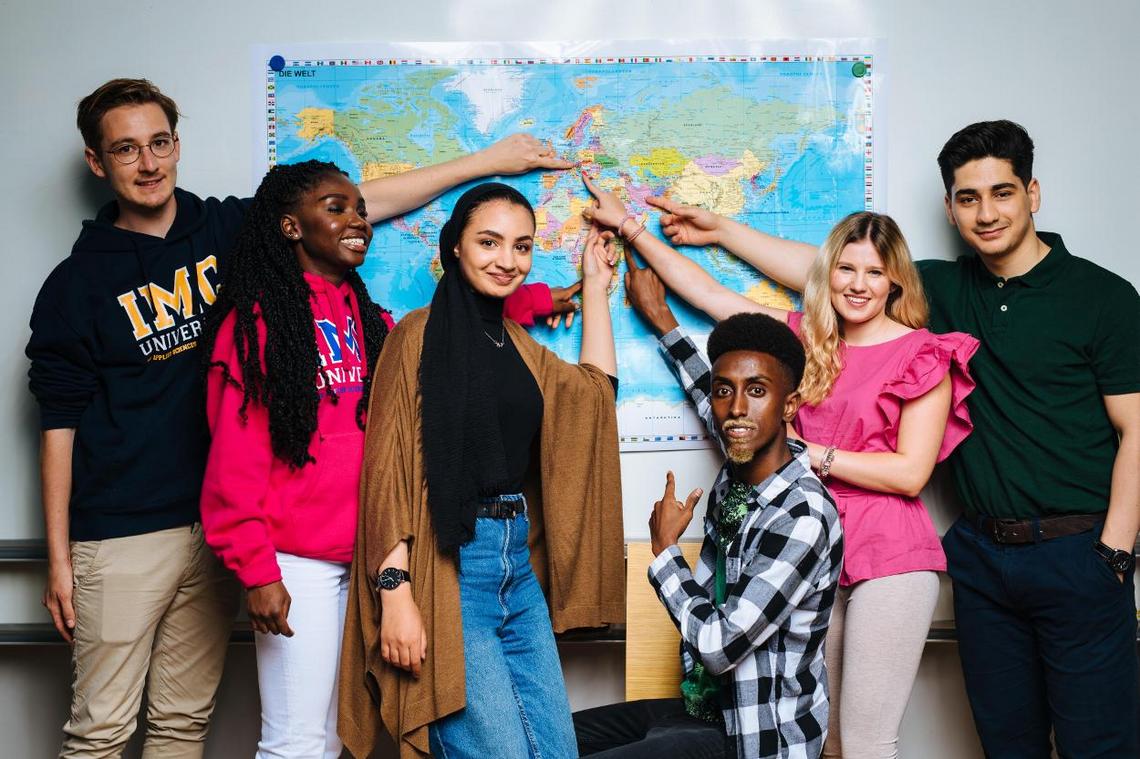 Students in front of a world map.