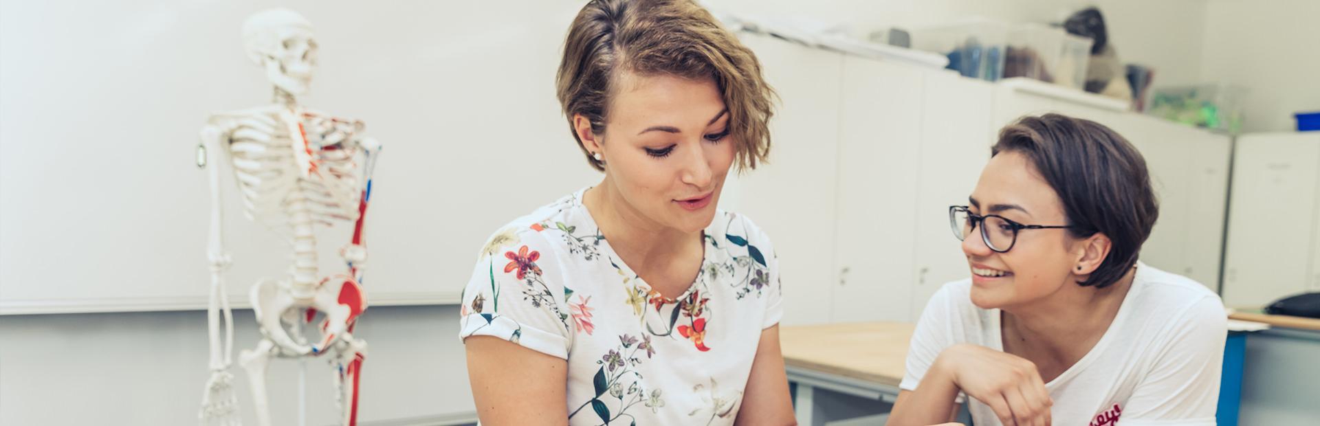 Zwei Personen in einer gesundheitswissenschaftlichen Lehrsituation.