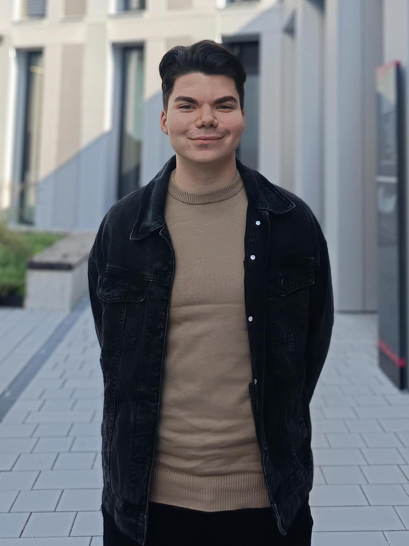 Szilard stands in front of the Tract U building at IMC Krems.